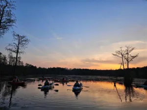 a group of 6 kayakers watching the sunset at Goodale State Park