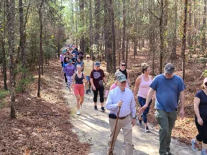 An image of a group of hikers on a Goodale State Park Trail, there are around 40 or 50 hikers.